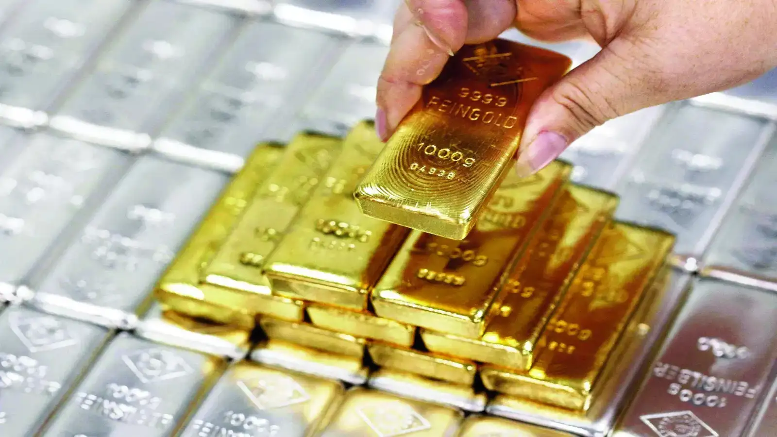 Gold bars and coins representing safe-haven investment
